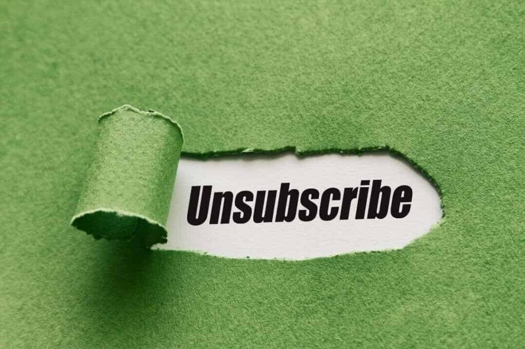 Zdarty zielony papier, a pod nim napis „unsubscribe”